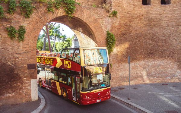 Big Bus Rome bus passing under an aqueduct